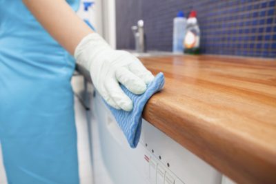 Cleaner polishing a kitchen counter in a Monument CO residence.